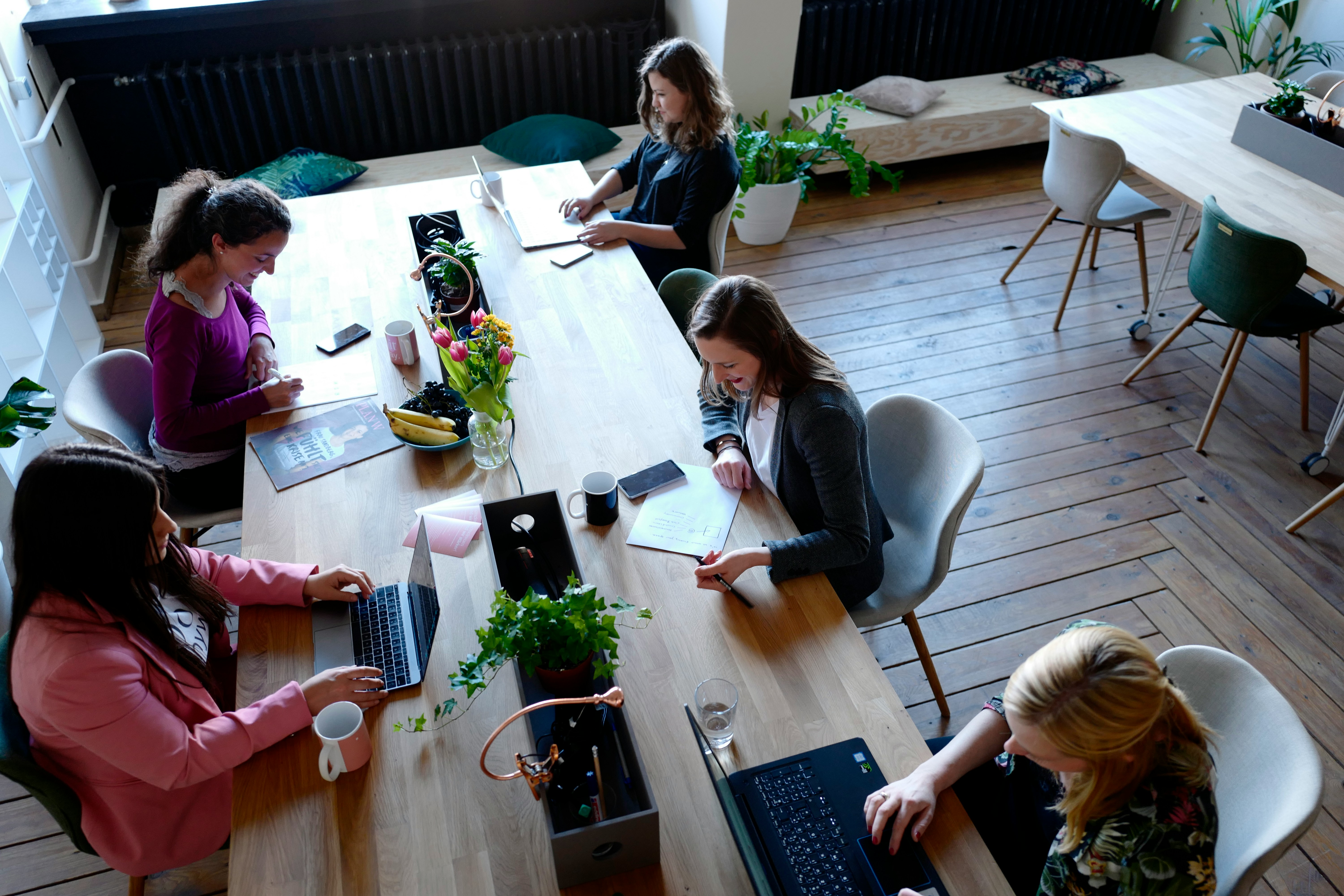 Photo of four individuals working in a modern office setting